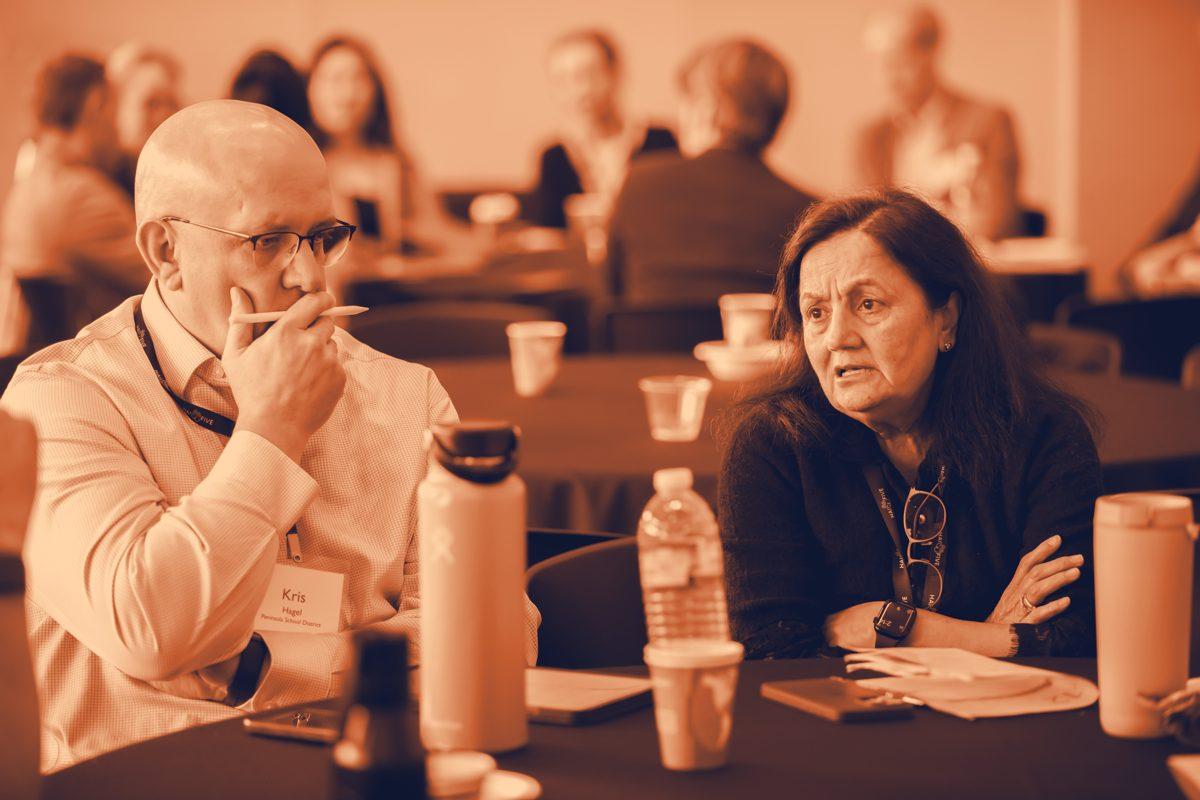Kris Hagel in conversation at a roundtable